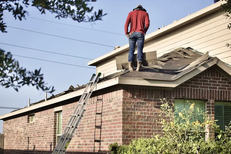 Professional roofer working on a residential roof in The Landings at Wellington